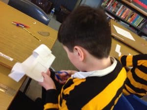 Young boy reading on tablet at Inchmarlo library.