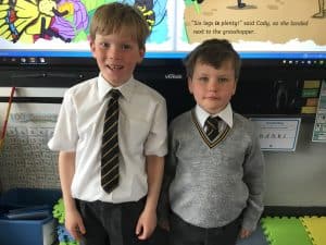 Two young boys in school uniforms at Inchmarlo, showcasing quality education and student diversity.