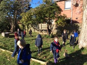 Children exploring Inchmarlo gardens in a scenic outdoor setting.