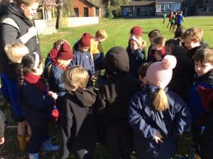 Children gathering outdoors at Inchmarlo School, amid lush greenery and scenic surroundings.