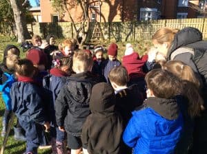 Group of children outdoors at Inchmarlo school in a sunny yard.