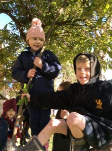 Young girl and boy enjoying outdoor play at Inchmarlo estate, surrounded by trees and nature.