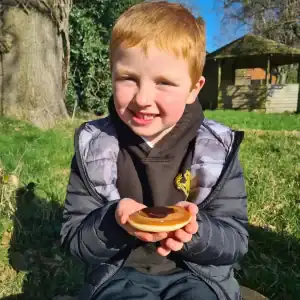 Kids enjoying outdoor activities at Inchmarlo, surrounded by lush greenery and trees.