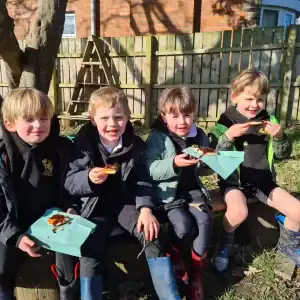 Happy children enjoying outdoor lunch at Inchmarlo School garden.
