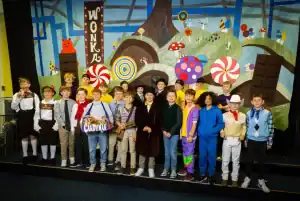 Children performing on stage at Inchmarlo, showcasing educational and extracurricular activities.