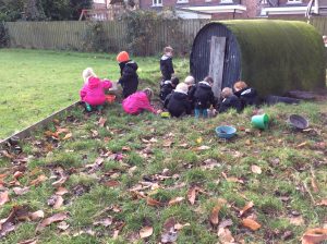 Children playing outdoors at Inchmarlo with playground equipment and natural scenery.