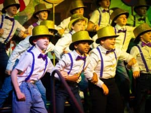 Children in colorful costume performing at Inchmarlo, showcasing school talent and community events.
