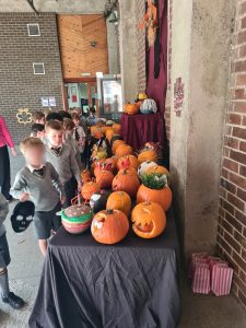 Children viewing carved pumpkins at Inchmarlo's festive event.