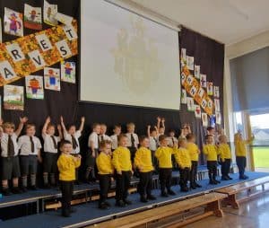 Children performing on stage at Inchmarlo School, engaged in a school event.
