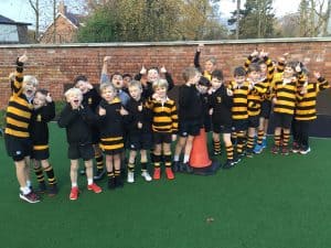 Children in rugby uniforms enjoying outdoor play at Inchmarlo.