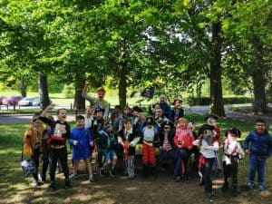 Group of children enjoying outdoor activity at Inchmarlo in lush green park setting.