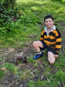 Young boy enjoying the outdoors at Inchmarlo estate, surrounded by lush greenery.