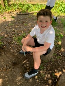 Happy boy exploring outdoors at Inchmarlo, enjoying nature and family-friendly activities.