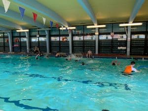 Indoor swimming pool at Inchmarlo with children enjoying swimming lessons and recreational activities.