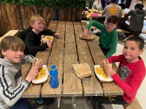 Children enjoying meals at Inchmarlo, a scenic location offering outdoor and indoor dining experiences.