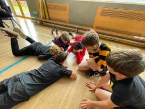 Children playing on the floor in a classroom setting.