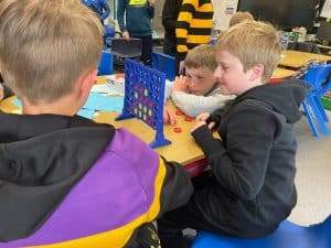 Children playing board games at Inchmarlo School, engaging in educational activities.
