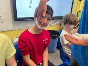 Young boy receiving a fun educational activity in class, engaging students at Inchmarlo School.