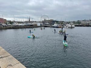 People paddleboarding and enjoying water activities at Inchmarlo.