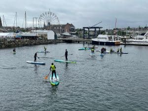 Outdoor water sports and paddleboarding on Inchmarlo’s scenic harbor in Scotland.