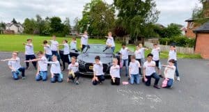 Group of children outdoors at Inchmarlo school, engaging in outdoor activities.