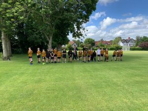 Children and adults enjoying outdoor activities at Inchmarlo with lush green lawns and trees.