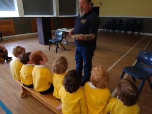 Children listening to a teacher in a classroom setting at Inchmarlo.