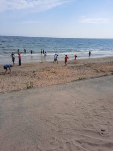 Children and families enjoying beach activities at Inchmarlo seaside resort.