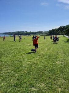 Children playing in Inchmarlo outdoor park, lush green space with lake views.
