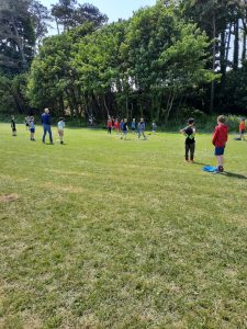 People playing golf at Inchmarlo Golf Course, surrounded by lush greenery and trees.