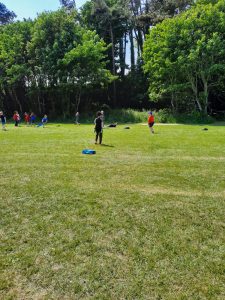 Family outdoor play area at Inchmarlo with kids enjoying nature and grass.