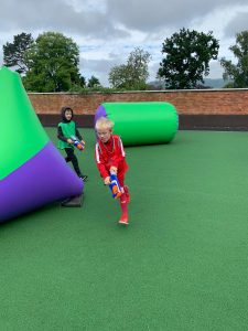 Children playing with water guns at Inchmarlo outdoor fun area.