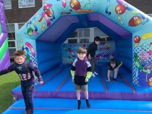Colorful inflatable bounce house with children playing at Inchmarlo outdoor activity center.