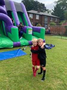 Children enjoying outdoor inflatable play area at Inchmarlo. Fun family activities in scenic surroundings.