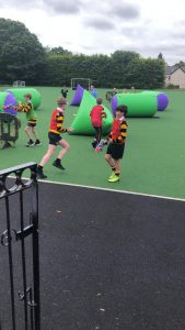 Kids enjoying inflatable obstacle course at Inchmarlo outdoor activity area.