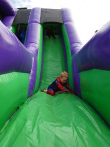 Colorful inflatable slide at Inchmarlo outdoor activity center.