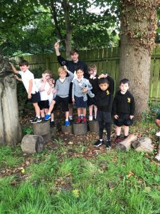 Children playing outdoors at Inchmarlo estate in a lush green garden.