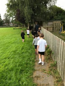 Children walking along a grassy outdoor path at Inchmarlo, enjoying nature and fresh air.