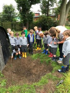 Children planting trees at Inchmarlo early education center.