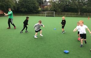 Children playing outdoor sports at Inchmarlo school field.