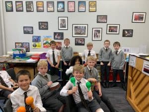 Group of young boys in school uniforms at Inchmarlo, Scotland, engaging in educational activities.