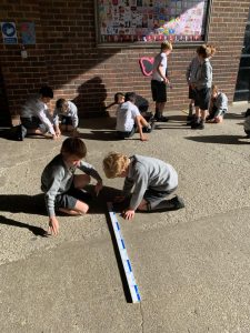 Children measuring outdoor play area at Inchmarlo school.