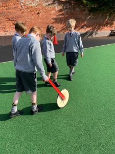 Children playing croquet outdoors at Inchmarlo, focusing on outdoor recreation and community activities.