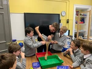 Kids engaging in a hands-on science activity at Inchmarlo School, fostering curiosity and learning in a nurturing environment.