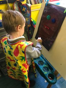 Child engaging in creative painting at Inchmarlo Children’s Centre.
