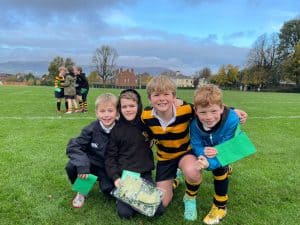 Photo of happy children playing on the school field at Inchmarlo, showcasing outdoor activities and vibrant school community.