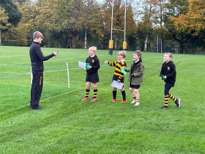 Children receiving awards on sports field at Inchmarlo, perfect for outdoor activities and sports events.