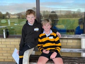 Two happy students at Inchmarlo School enjoying outdoor activities.