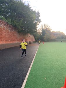Child running on sports track at Inchmarlo outdoor area.