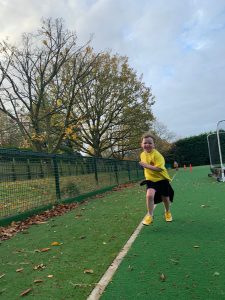 Child running outdoors on sports field in athletic wear at Inchmarlo.